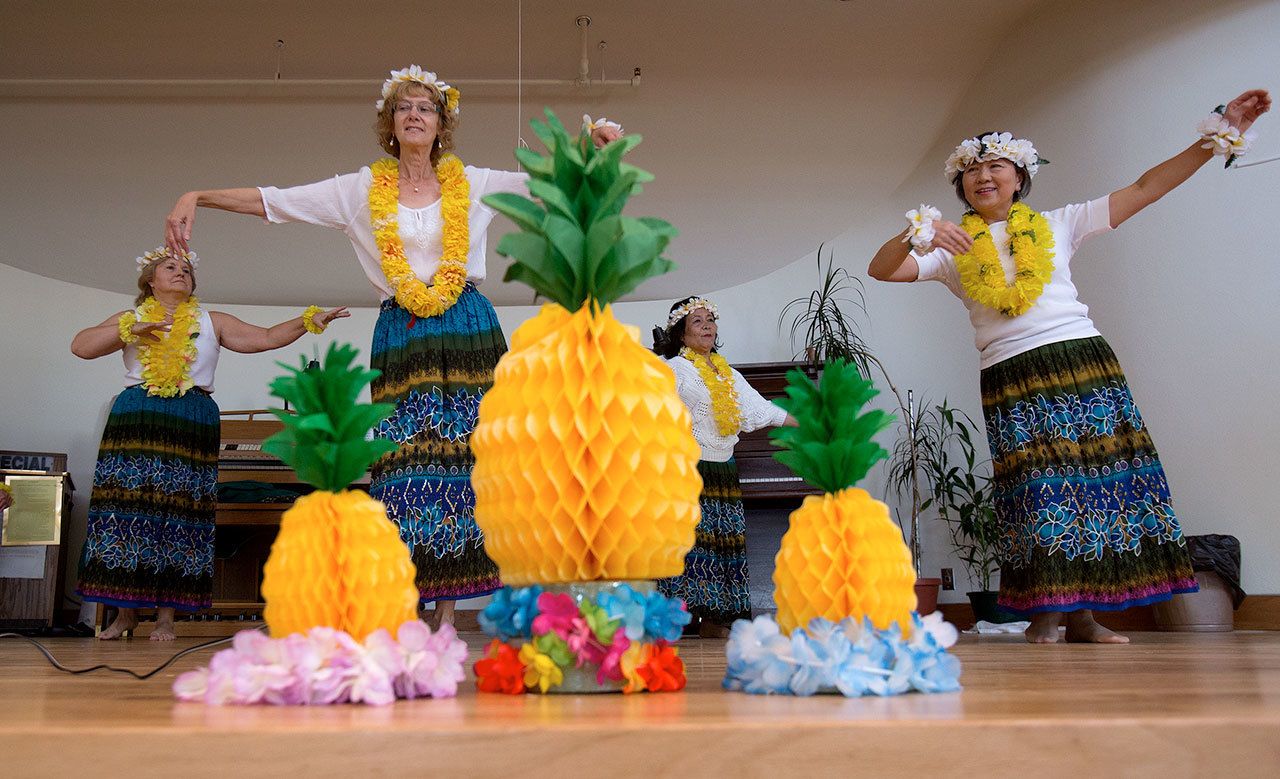 Dancers perform hula dances as The Carl Gipson Senior Center in Everett re-opens with an Aloha Party on Monday. The center had been closed for remodeling since early July. (Andy Bronson / The Herald)