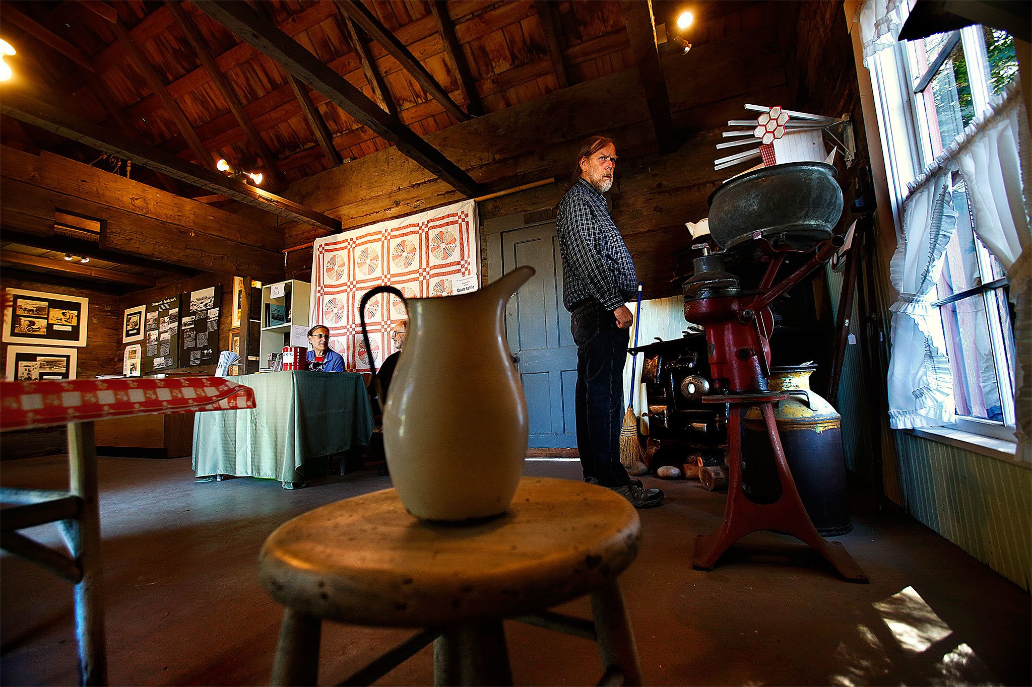 While many visitors to the 130-year-old Shannahan Cabin at the fairgrounds just want to browse, Monroe Historical Society Volunteer docents, Gail Dillaway (left) and Michael Mates are on hand to answer questions about the unique structure and its history. (Dan Bates/The Herald)