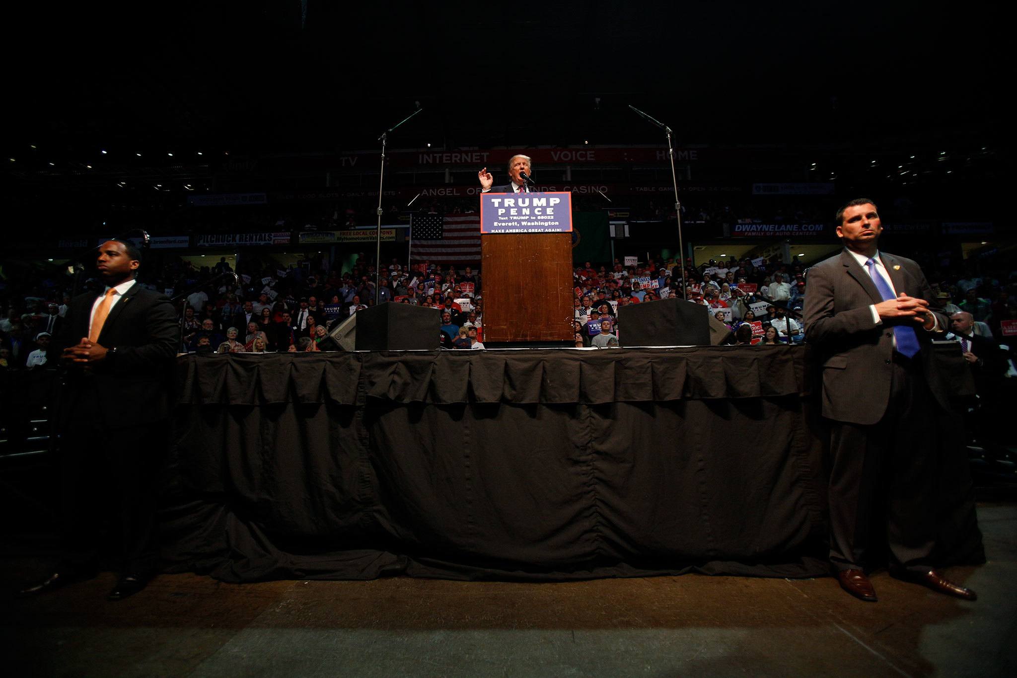Secret Service agents guard Donald Trump as he speaks to a nearly full Xfinity Arena on Tuesday in Everett. (Andy Bronson / The Herald)