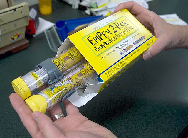 A pharmacist holds a package of EpiPens epinephrine auto-injector, a Mylan product, in Sacramento, California, on July 8. Mylan said it will make available a generic version of its EpiPen, as criticism mounts over the price of its injectable medicine. (AP Photo/Rich Pedroncelli, File)