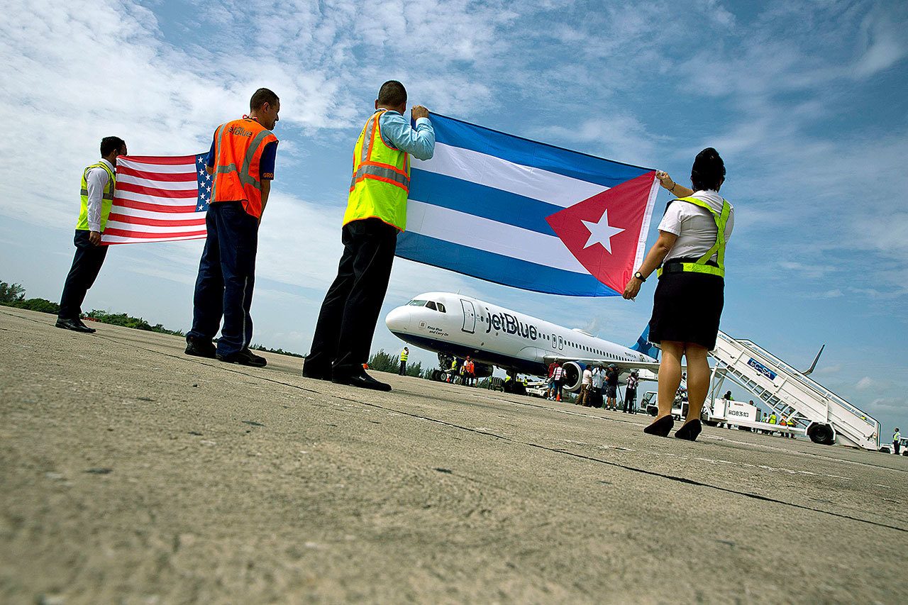 Bearing United States and Cuban flags, airport workers greet the arrival of JetBlue flight 387 on the tarmac in Santa Clara, Cuba, on Wednesday. (AP Photo/Ramon Espinosa)