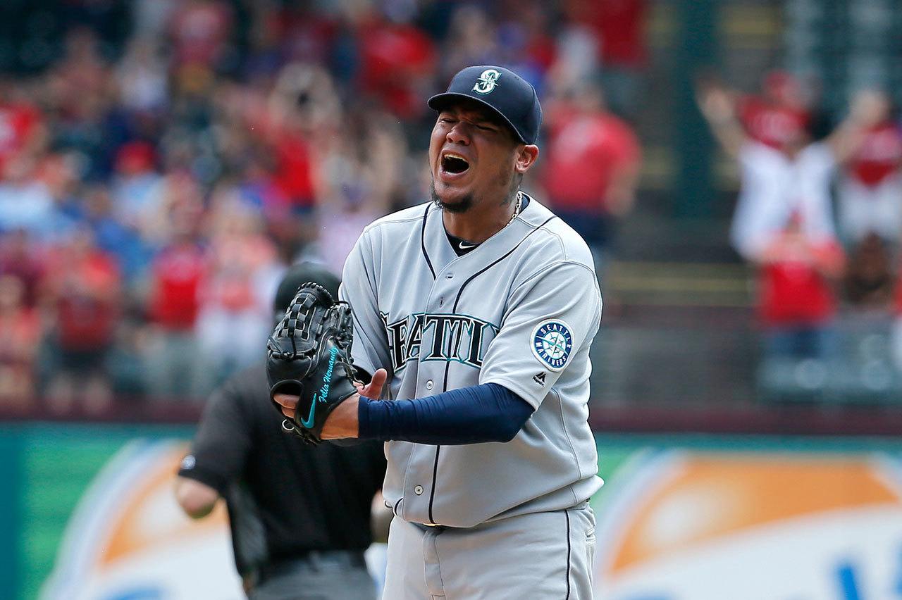 Seattle Mariners starting pitcher Felix Hernandez punches his glove after giving up a grand slam to Carlos Gomez in the fourth inning of Wednesday’s game in Arlington, Texas. The Mariners lost to the Texas Rangers, 14-1. (AP Photo/Tony Gutierrez)