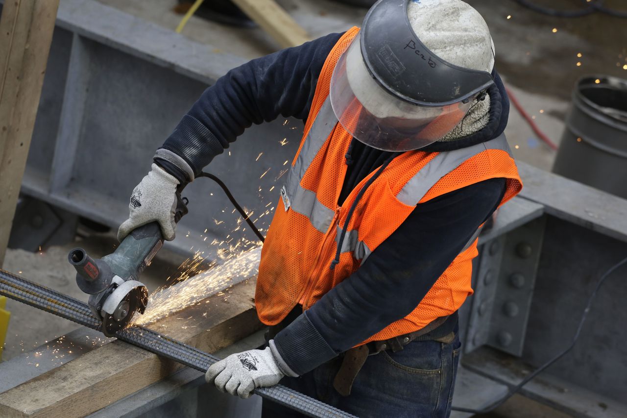 Sparks fly as a construction worker uses a grinder to cut through steel reinforcing bars this month in New York.