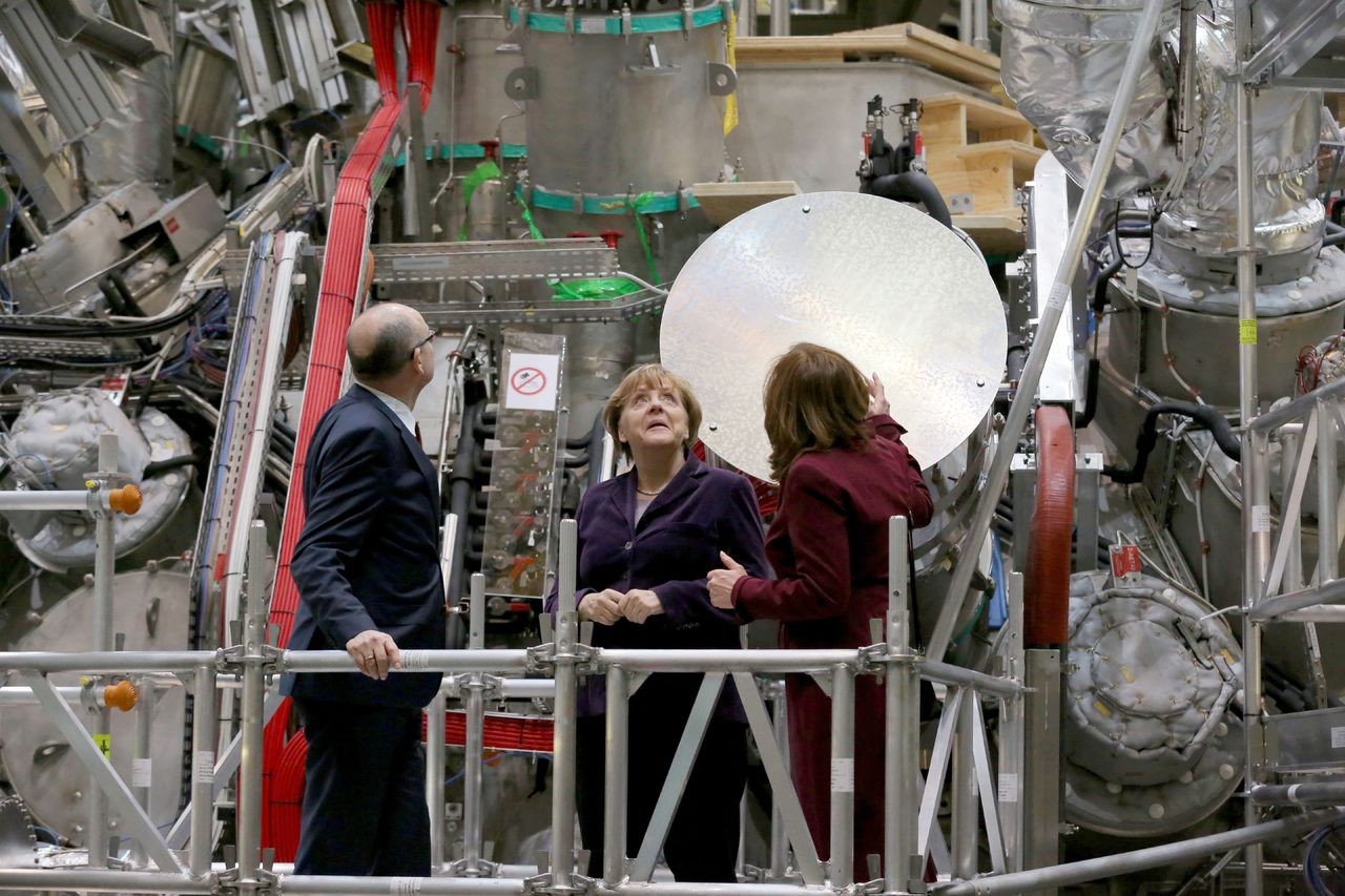 German Chancellor Angela Merkel, center, visits the Wendelstein 7-X nuclear fusion research centre in Greifswald, Germany, on Wednesday after the plant created plasma from hydrogen for the first time.