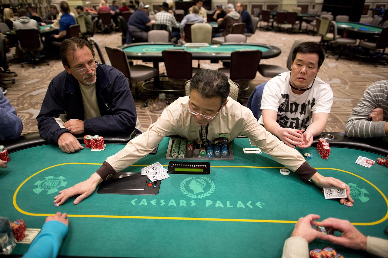 A dealer gathers up chips after a hand of Texas Hold ‘em at Caesar’s Palace in Las Vegas in 2013.