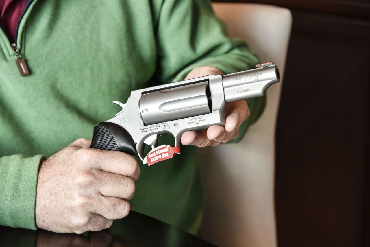 Lance Toland, the owner of an aviation insurance company, holds a Taurus revolver in Atlanta in February.
