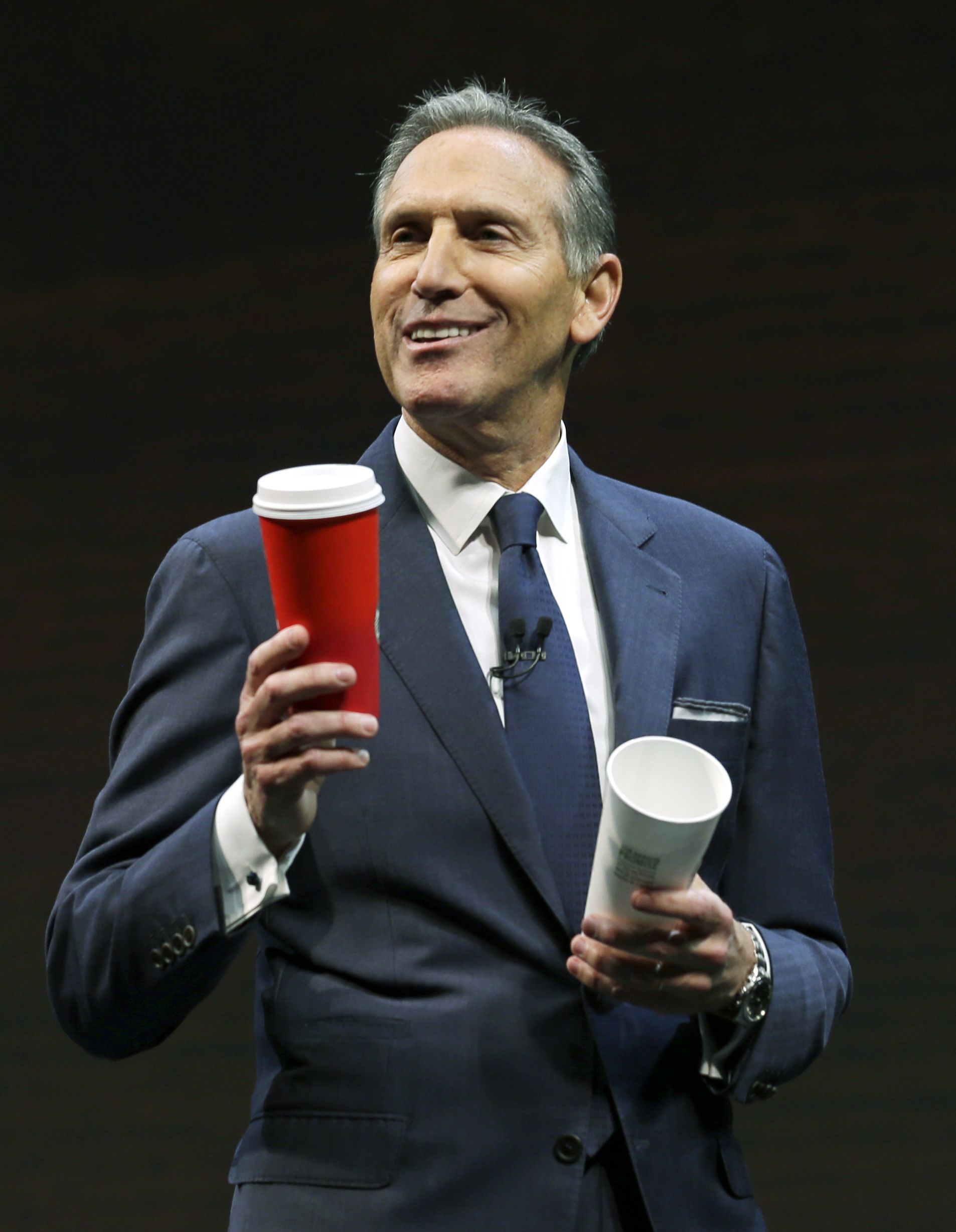 Starbucks CEO Howard Schultz holds one of the company’s red holiday cups as he speaks Wednesday at the company’s annual shareholders meeting in Seattle.