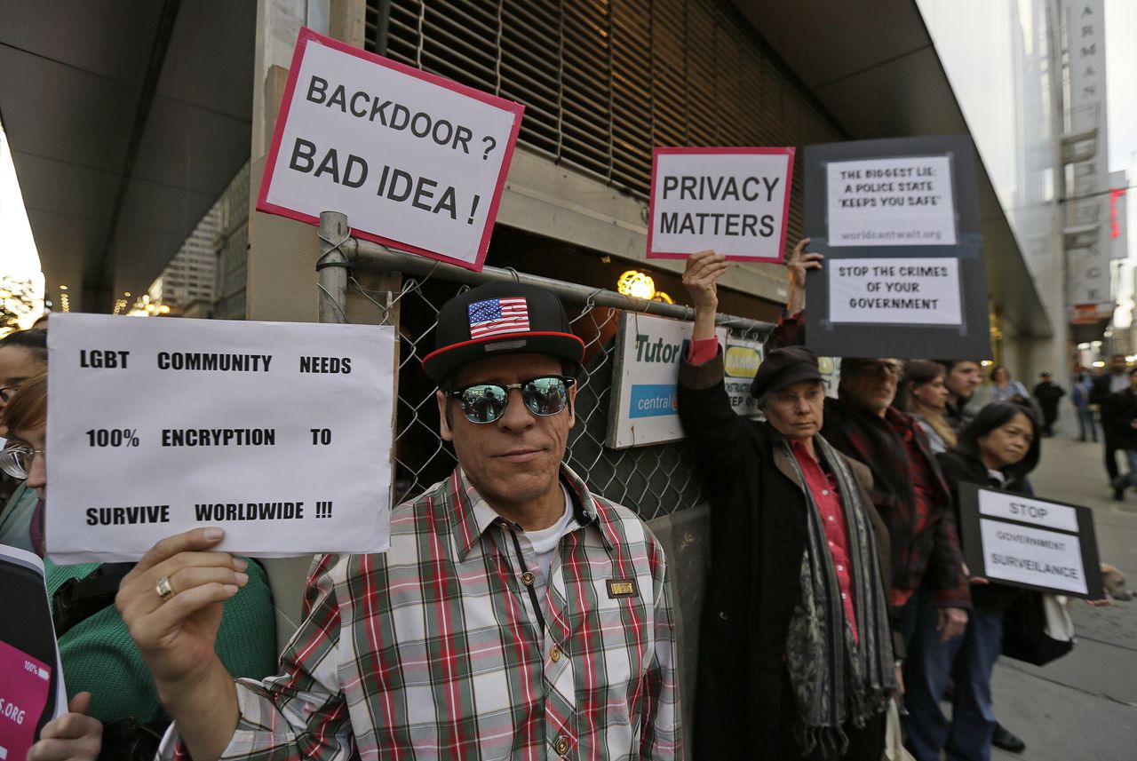People hold up signs during a rally in support of data privacy outside the Apple store Feb. 23 in San Francisco. Protesters assembled in more than 30 cities to lash out at the FBI for obtaining a court order that requires Apple to make it easier to unlock an encrypted iPhone used by a gunman in December’s mass murders in California.