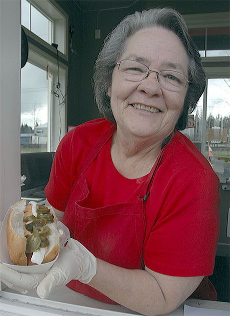 My Awesome Dogs owner Melody Patrick holds out her Marysville-style hot dog with cream cheese, jalapenos and Sriracha sauce. She specializes in regional hot dogs at her business at 13901 Smokey Point Blvd., Marysville.