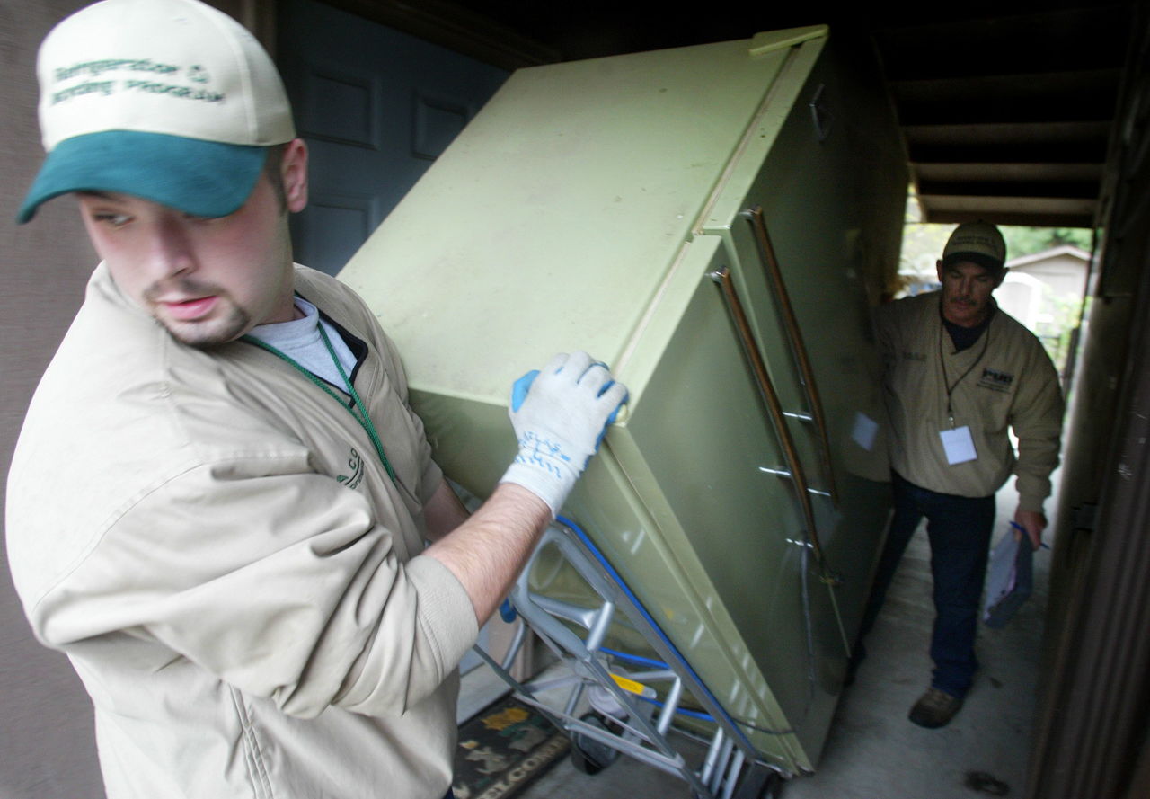 Jaco Environmental workers remove an old refrigerator from a south Everett home in this photo from 2005. Jaco, which was based in Snohomish County, but had centers across the country, went out of business In November after the price of metal plummeted.