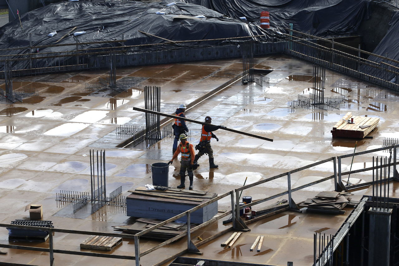 Andy Bronson / The Herald A parking garage deck is worked on as construction of the seven-story apartment building called CityCenter Apartments on Wednesday, Feb. 10, 2015 in Lynnwood, Wa. Lynnwood is experiencing a jolt of construction with two dozen major projects and more than $1 billion in development under way or soon to be underway.