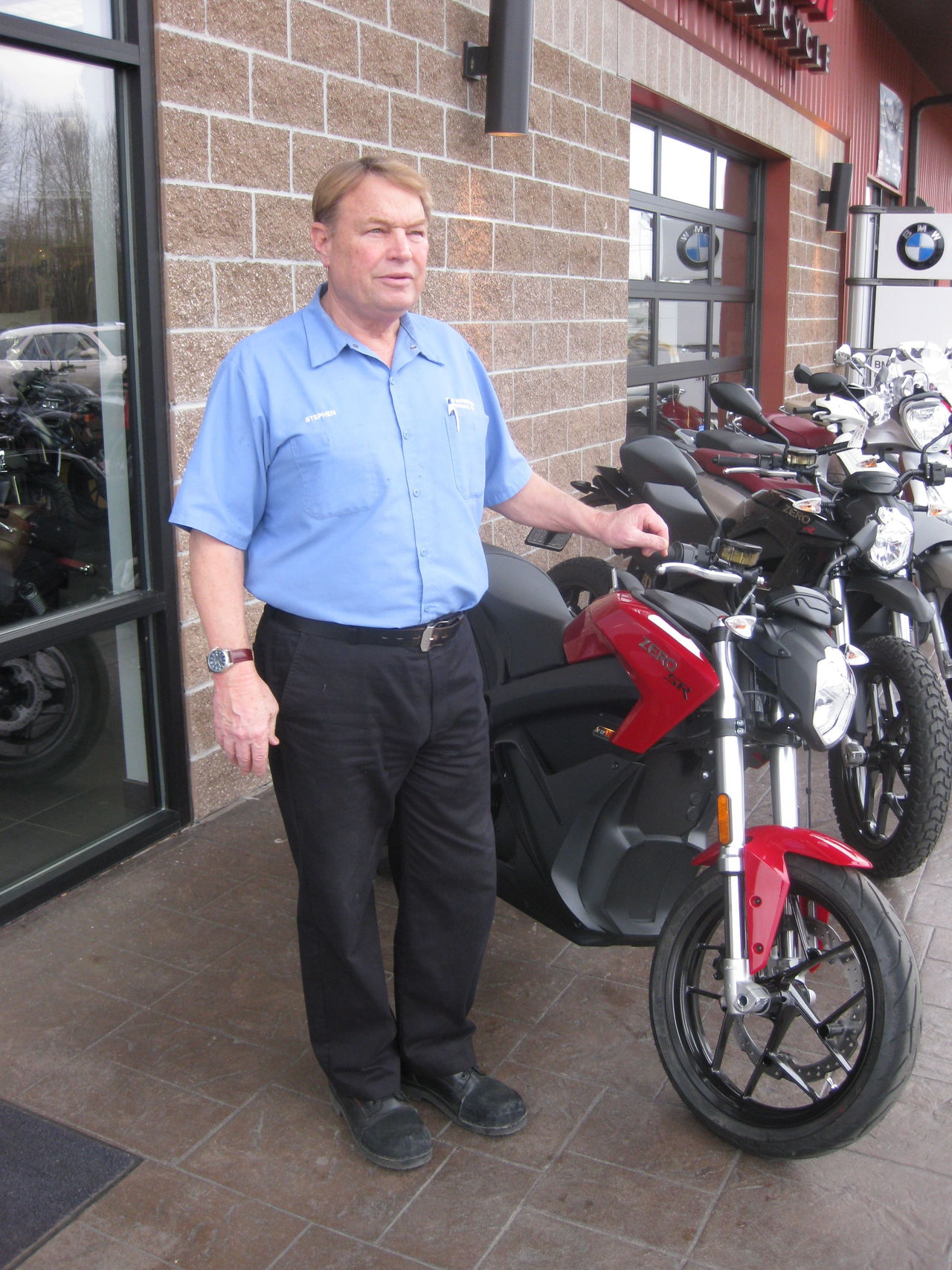 Stephen McBee, who owns Pacific Northwest Motorcycles in Ferndale, stands next to one of the electric Zero Motorcycles that his business is sellilng.