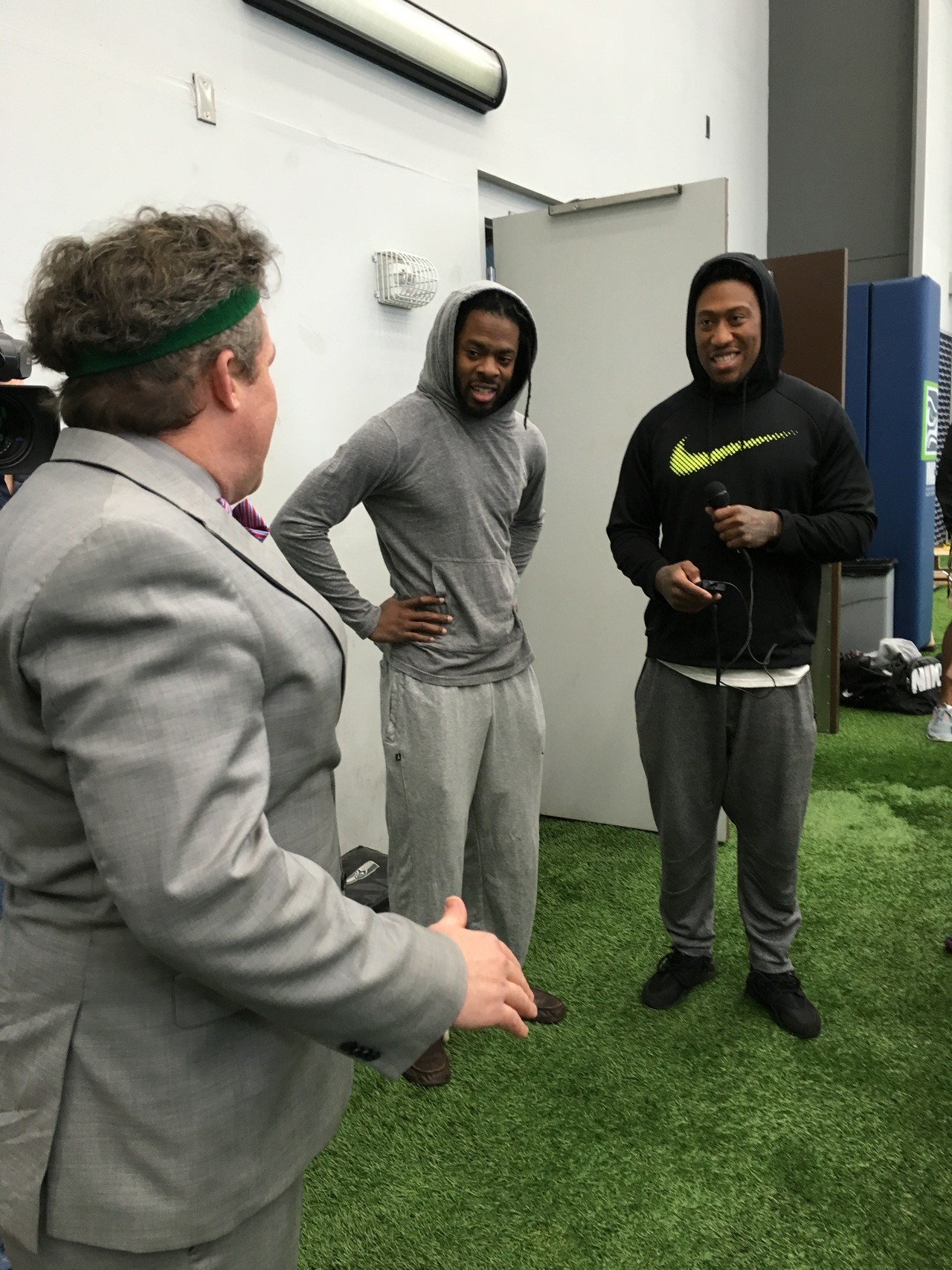 Seahawks players Richard Sherman (middle) and Bruce Irvin (right) were among those who showed up to heckle the media members (including 710 AM’s Danny O’Neil, who did the drills in a suit) during the first annual Seattle media combine Monday at the Virginia Mason Athletic Center.