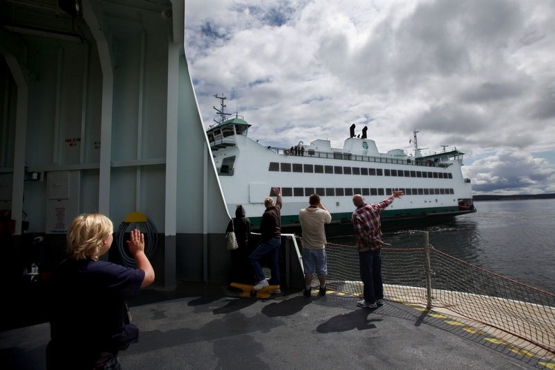 Michael O’Leary / Herald file photo, 2011 Washington State Ferries has released its spring 2016 sailing schedules. Here, visitors to the Salish wave to the Chetzemoka as it sails from Port Townsend to Keystone on June 30, 2011.