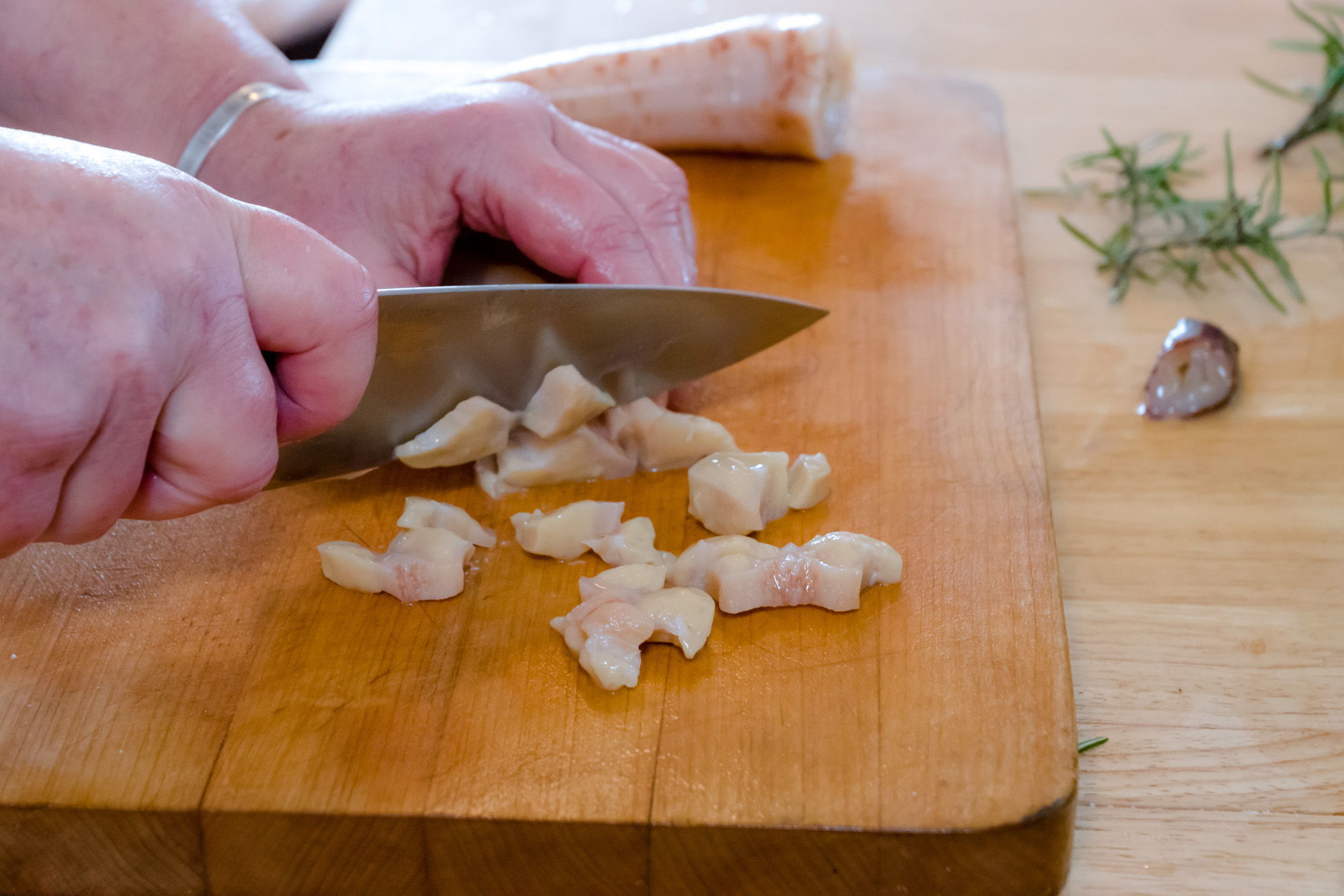 To prevent rubbery bites, the geoduck is chopped into small bite-sized pieces.