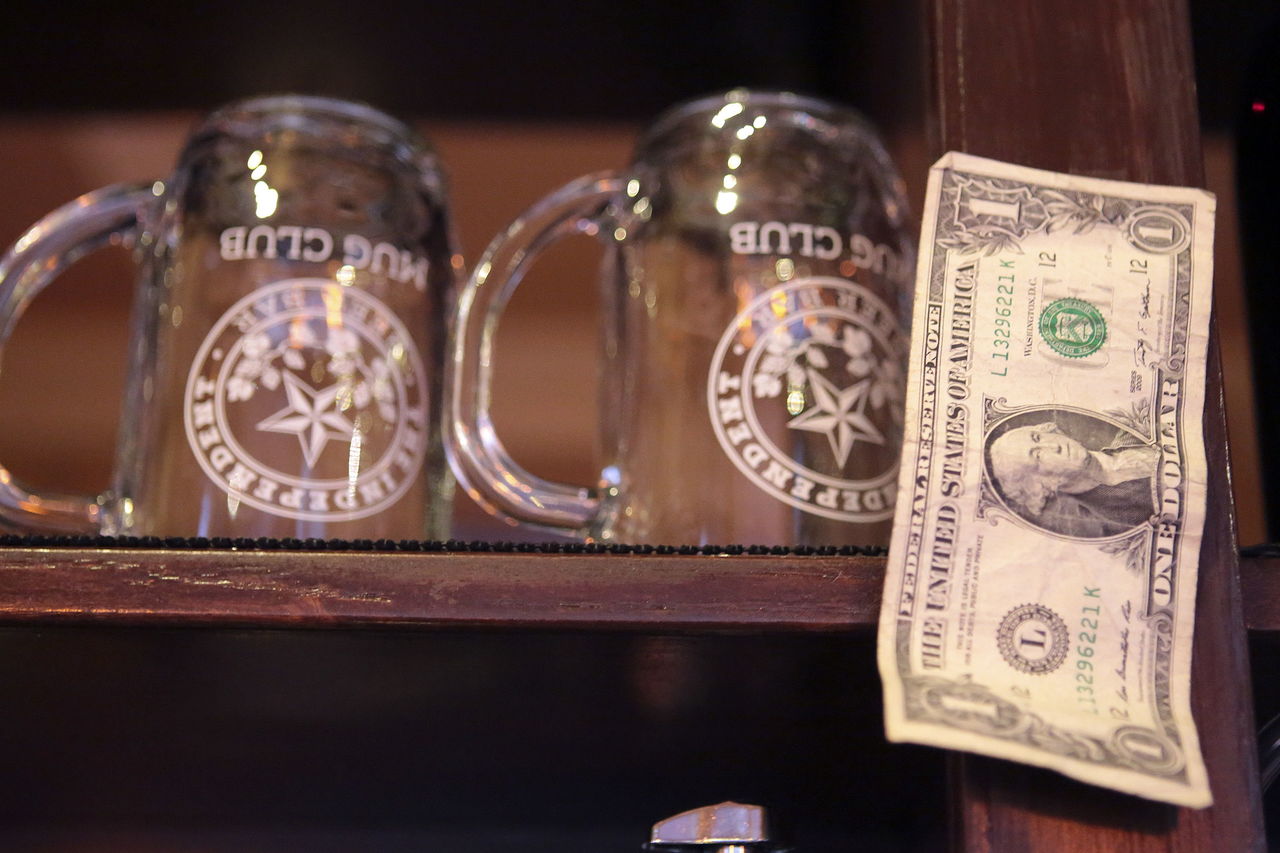 The first dollar Doug Hall and Jeff Sadighi earned decorates their new beer bar in downtown Everett.