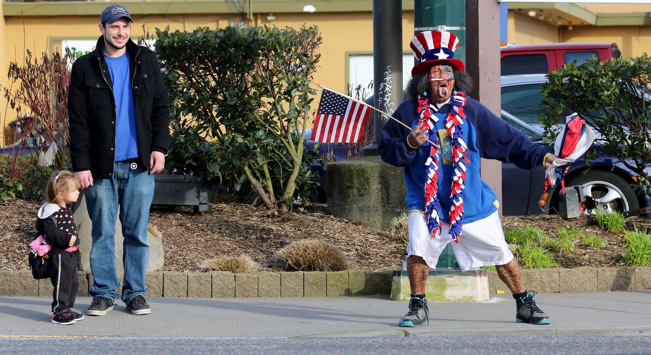 Samiu Bloomfield performs his patriotic sideshow from the sidewalk on Broadway in Everett, basking in the attention from motorists and foot traffic.