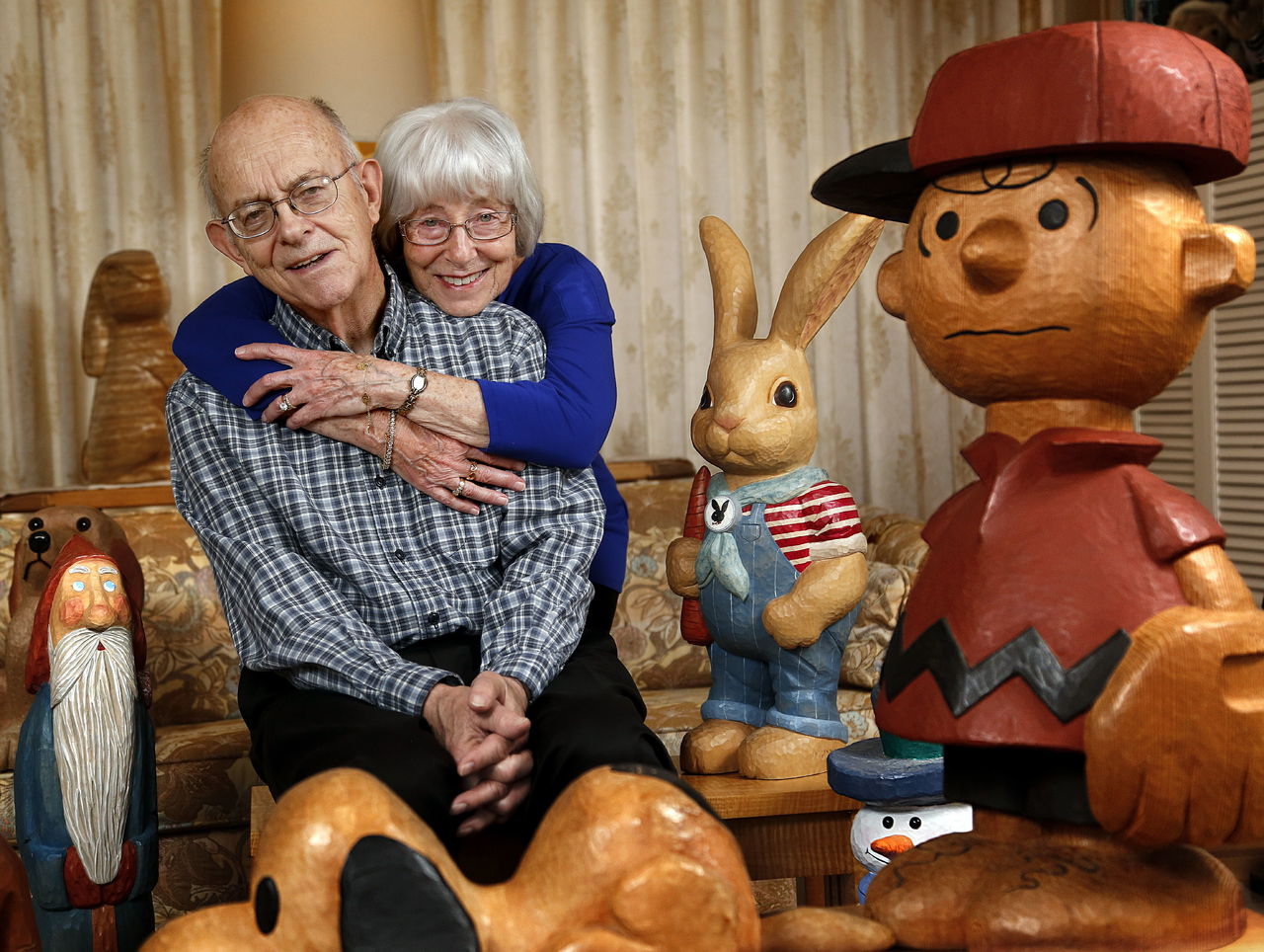 At home in Everett, Ed and Betty Morrow, both 81, enjoy the company of some of Ed’s lifelike creations last week. The Morrows were honored by the Everett Museum of History for long-time community involvement, plus their efforts to establish a much-needed museum in Everett.