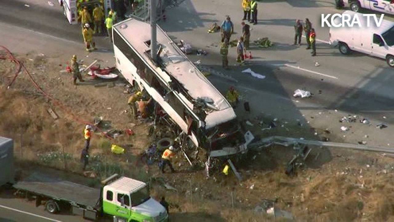 This still frame from video shows authorities investigating the scene of a charter bus crash on northbound Highway 99 between Atwater and Livingston, California, on Tuesday. (KCRA3-TV via AP)