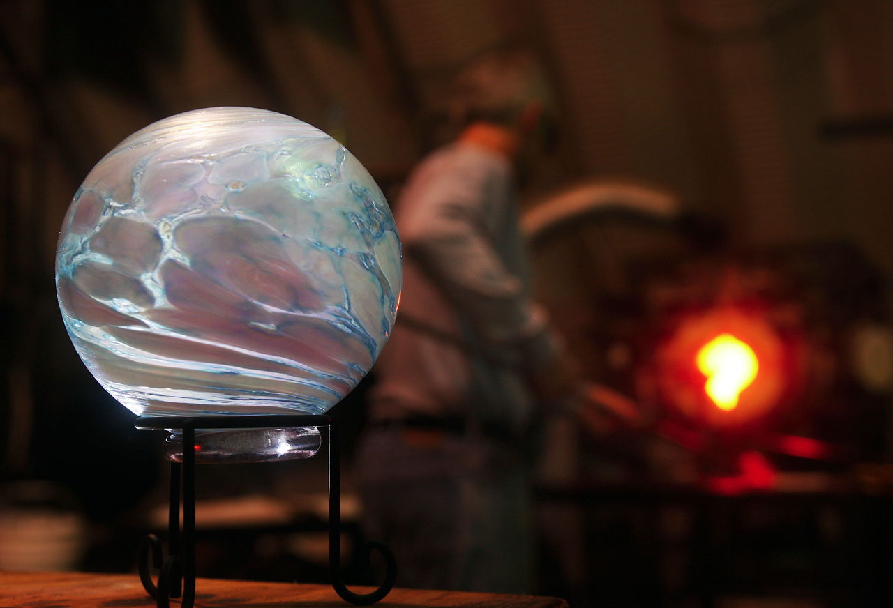 Mark Ellinger heats glass in his Stanwood studio in 2010. On a table in front of him is a glass float for the Great Northwest Glass Quest.