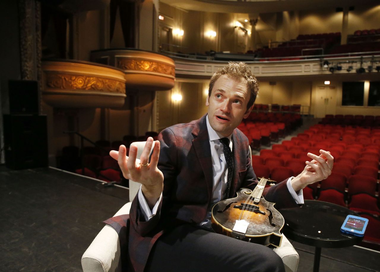 Chris Thile gestures during an interview at the Fitzgerald Theater in St. Paul, Minn. Thile will replace Garrison Keillor as host of “A Prairie Home Companion,” the popular public radio variety show, after Keillor retires this summer. Thile starts hosting a 13-episode run of the show in October.
