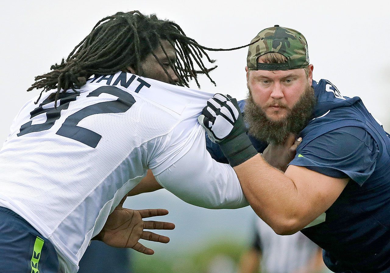 Seattle Seahawks offensive lineman Mark Glowinski (right) blocks defensive tackle Brandin Bryant during a practice session earlier this month in Renton. (AP Photo/Ted S. Warren)