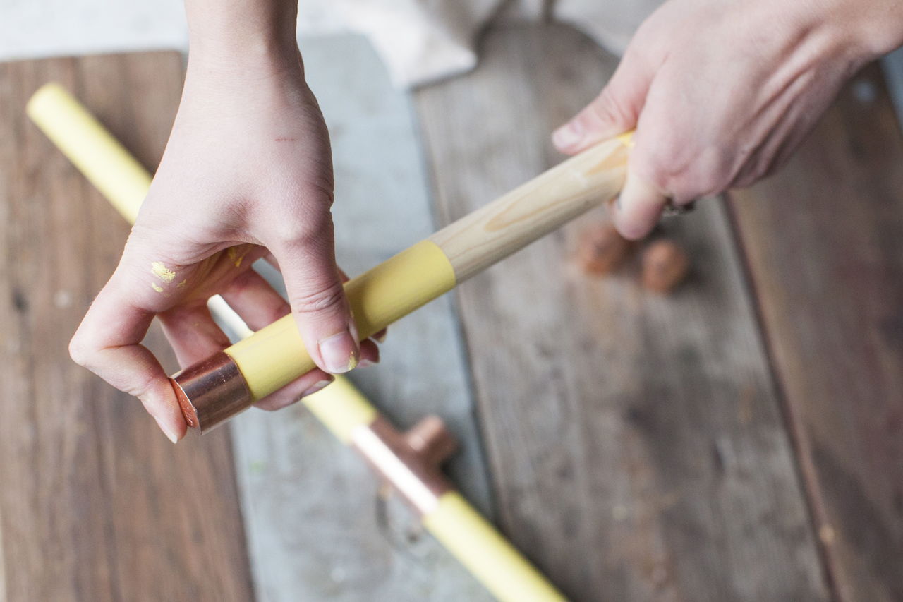 Step 7: Apply wood glue to the exposed ends of the top and bottom dowels, and slip on a copper cap.
