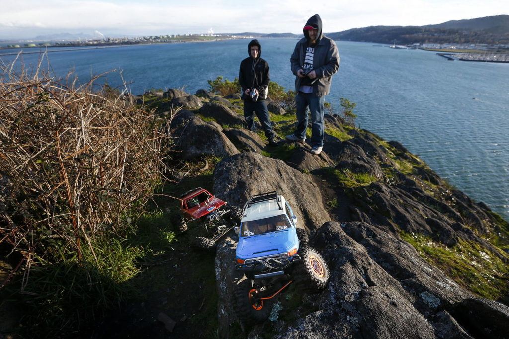 Bubba Thorp (right) and Tony Martini use the rocky terrain at Cap Sante Park in Anacortes to practice with their remote control crawlers on Feb. 18 The park offers a view of downtown Anacortes and Fidalgo Bay.
