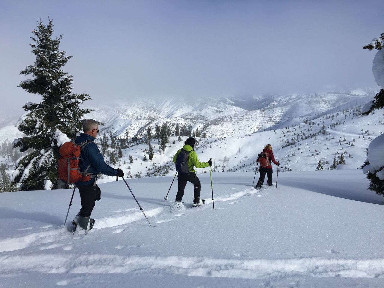 Leo Hennessy, DeEtta Petersen and Bea Purchase snowshoe toward the Banner Ridge yurt in Idaho City, Idaho.