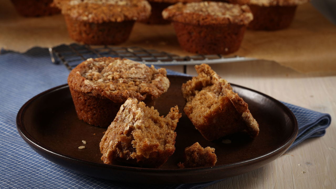 Rolled oats bring texture to a crumble that tops muffins spiked with cinnamon and nutmeg.
