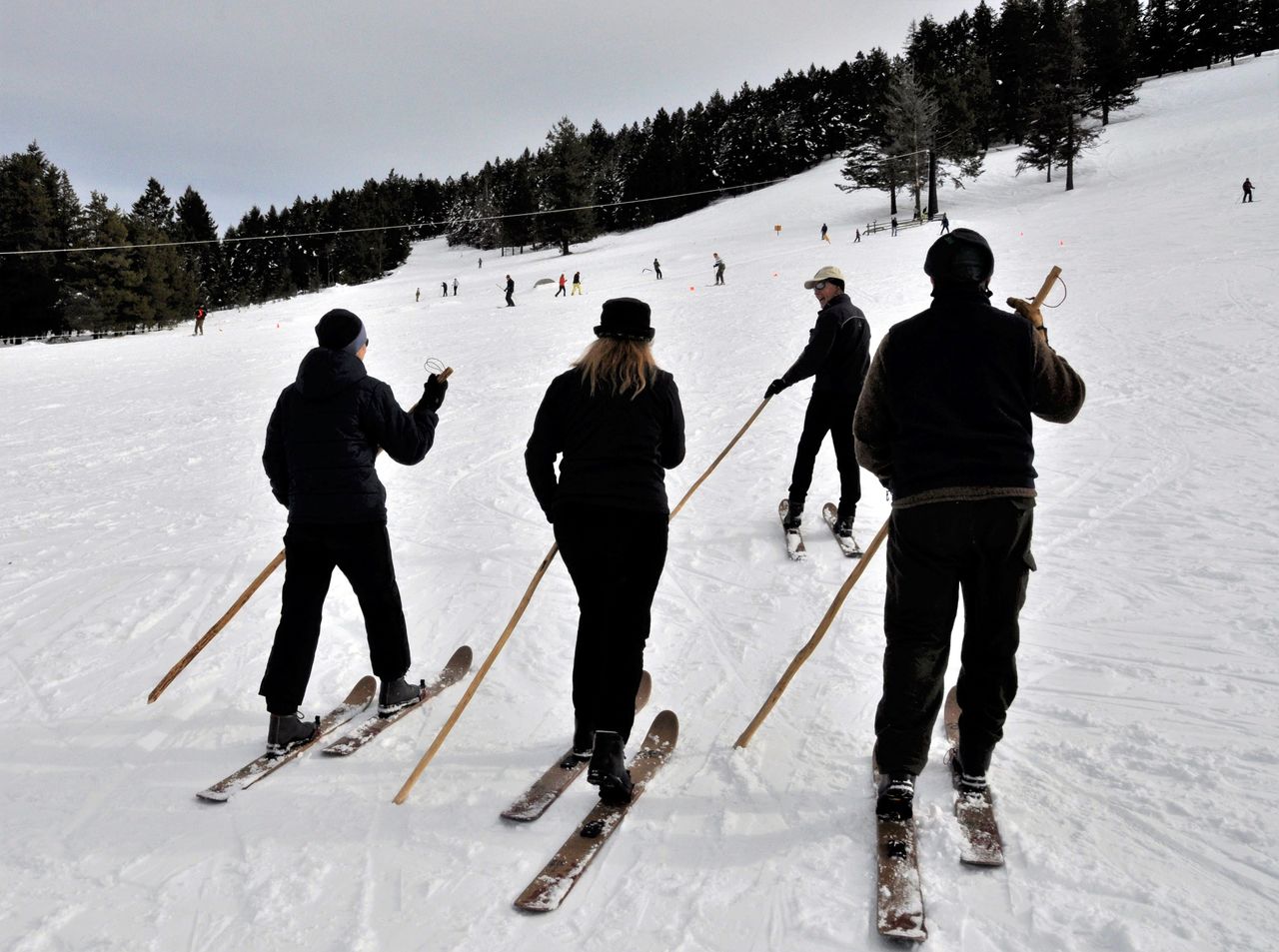 Don Portman leads a group of skiers trying out Altai Hok skis at Sitzmark Ski Area. Instead of ski poles, they each hold a single tiak used for centuries by herdsmen in the Altai Mountains of northern Asia.