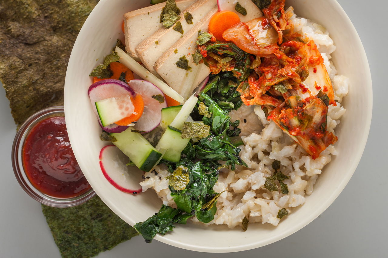 You can make the Korean dish bibimbap pretty much any way you want. The important thing is a rich mix of colors and textures. This recipe uses kimchi and smoked tofu.