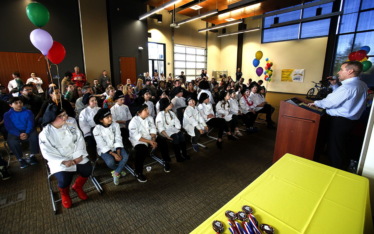 In the main event room, the 22 elementary school cooks sit in two rows for the awards presentation, which was kicked off by nutrition services manager, Brad Wall at right.
