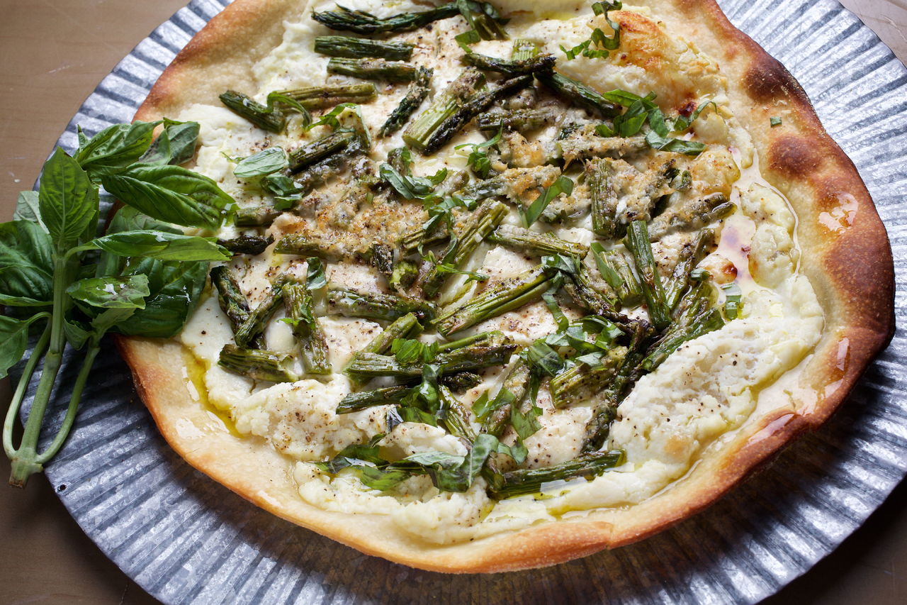 Use pre-made pizza dough to make asparagus and ricotta pizza, which is perfect for a spring meal.