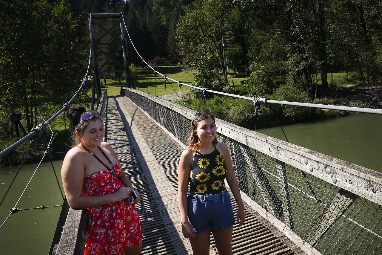 Courtney Lewis (left) and Abbie Ward of Fall City take in the view from a footbridge that spans the Snoqualmie River at Tolt-MacDonald Park in Carnation. The park offers overnight camping, hiking and mountain bike trails.