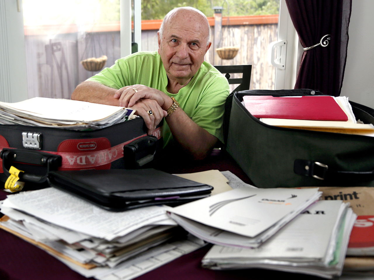 At his home in Lake Stevens, Viorel Ciubuc pulls out just a few of his suitcases stuffed with paperwork from his eight-year-long suit against those who persecuted him in Romania. Despite odds against him in that part of the world, his suit was successful.