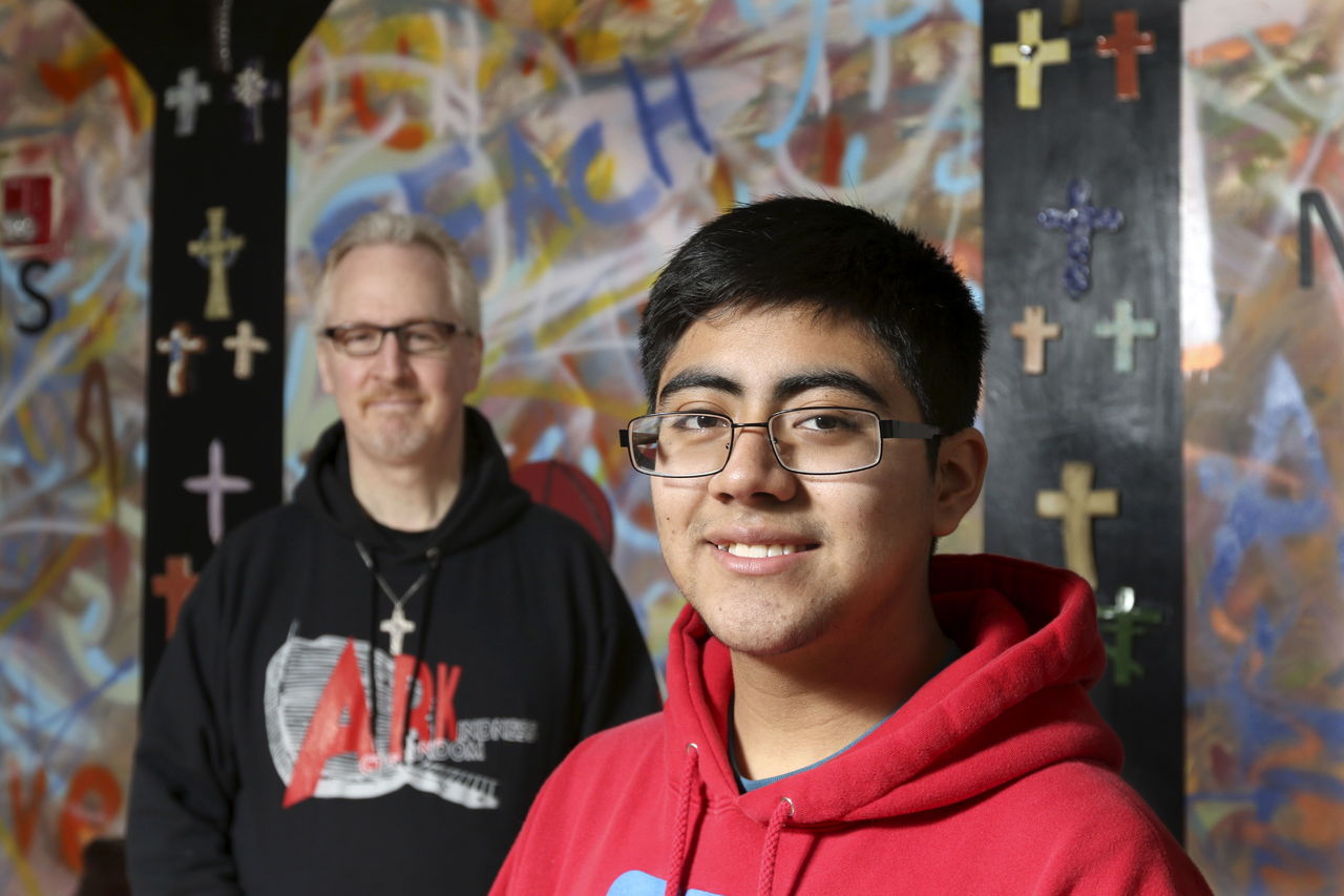 Guillermo Reyes, a sophomore at Archbishop Murphy High School, with help from Deacon Dennis Kelly, raised about $7,000 to help families displaced by a New Year’s Eve fire.