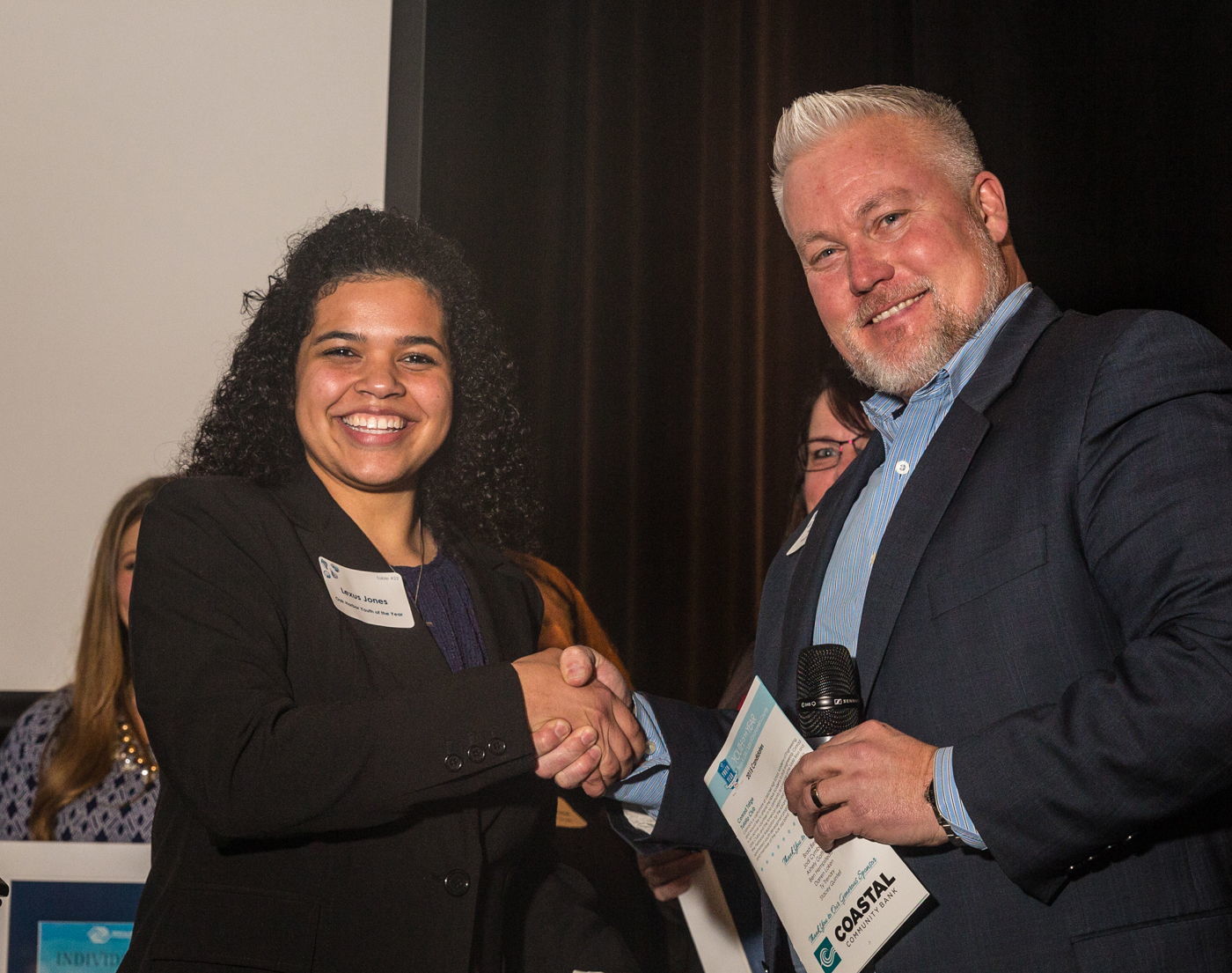Judge Darren Loken, president of K&H Printers, congratulates the Boys & Girls Clubs of Snohomish County 2015 Youth of the Year Lexi Jones.