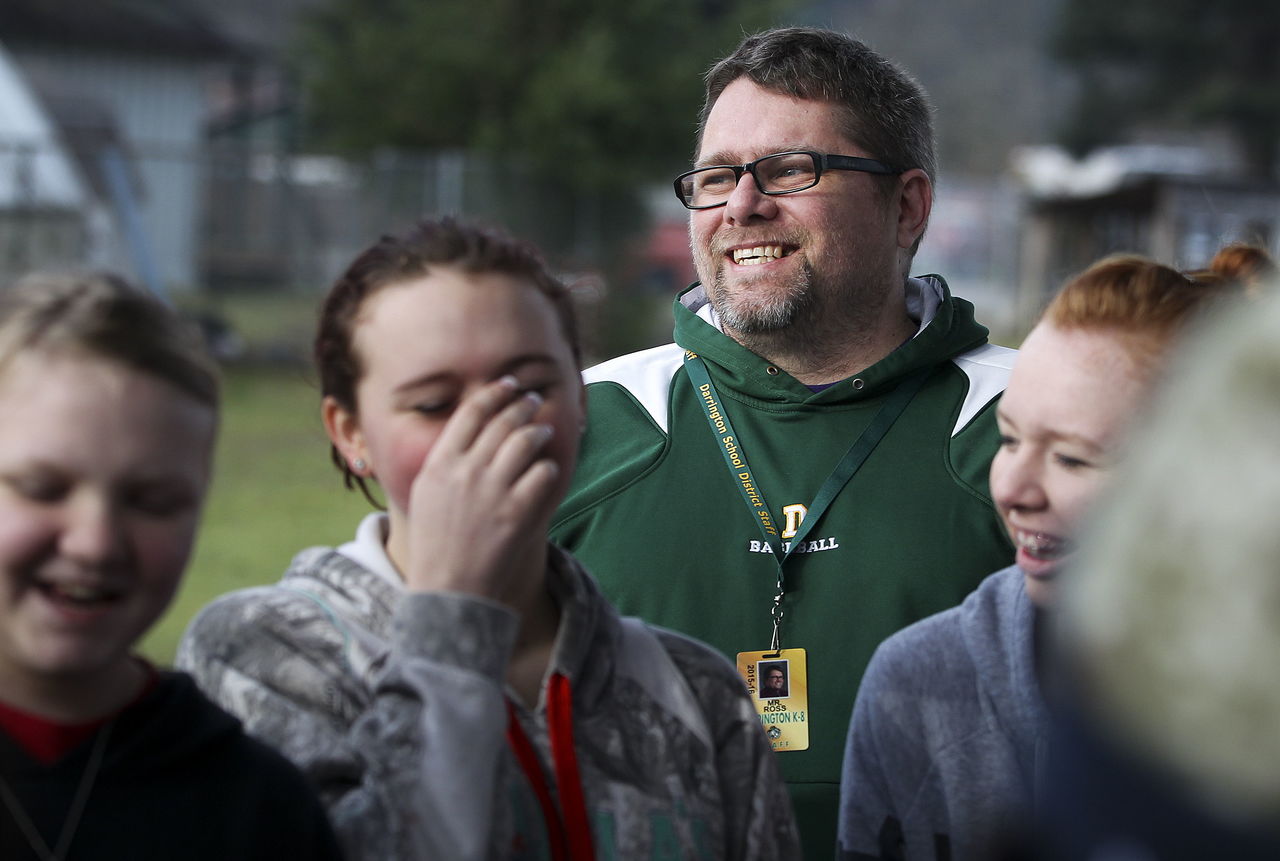 Darrington Middle School teacher Cam Ross laughs with students during a class activity outside Wednesday. Ross’ cousin, Cory, also teaches at the school.