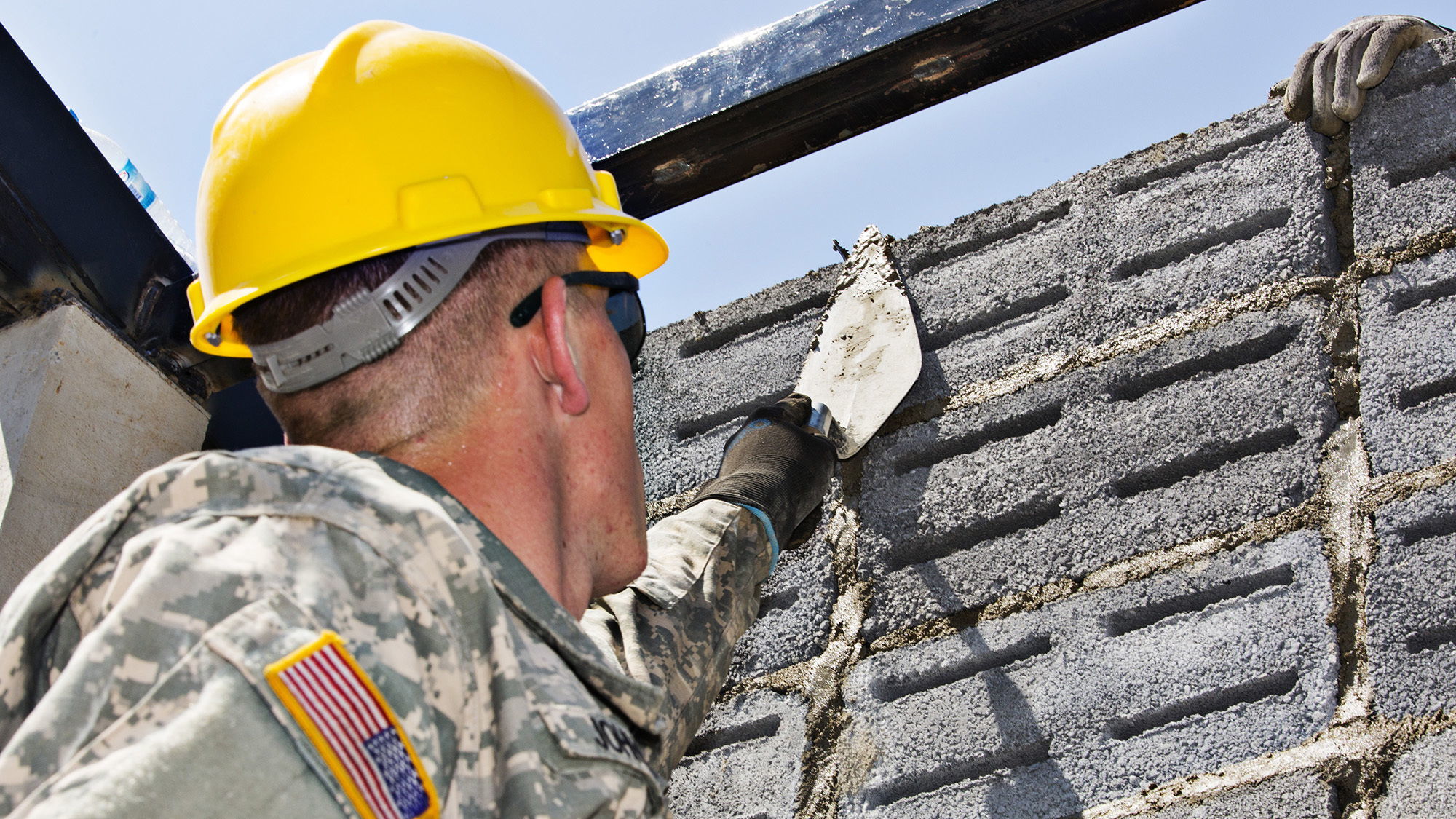 U.S. Army Pvt. Josh Johnson, a plumbing and pipefitting specialist with Washington National Guard’s 176th Engineering Company (Vertical), based out of Snohomish, and a native of Bothell, lays ventilation blocks at Ban Sub Prik Elementary School, located in Muak Lek District, Saraburi Province, Thailand, on Feb. 3, 2015. The 176th Engineer Co., which frequently helps construct schools in Thailand, is now being deployed to Kuwait in support of ongoing missions in the area.