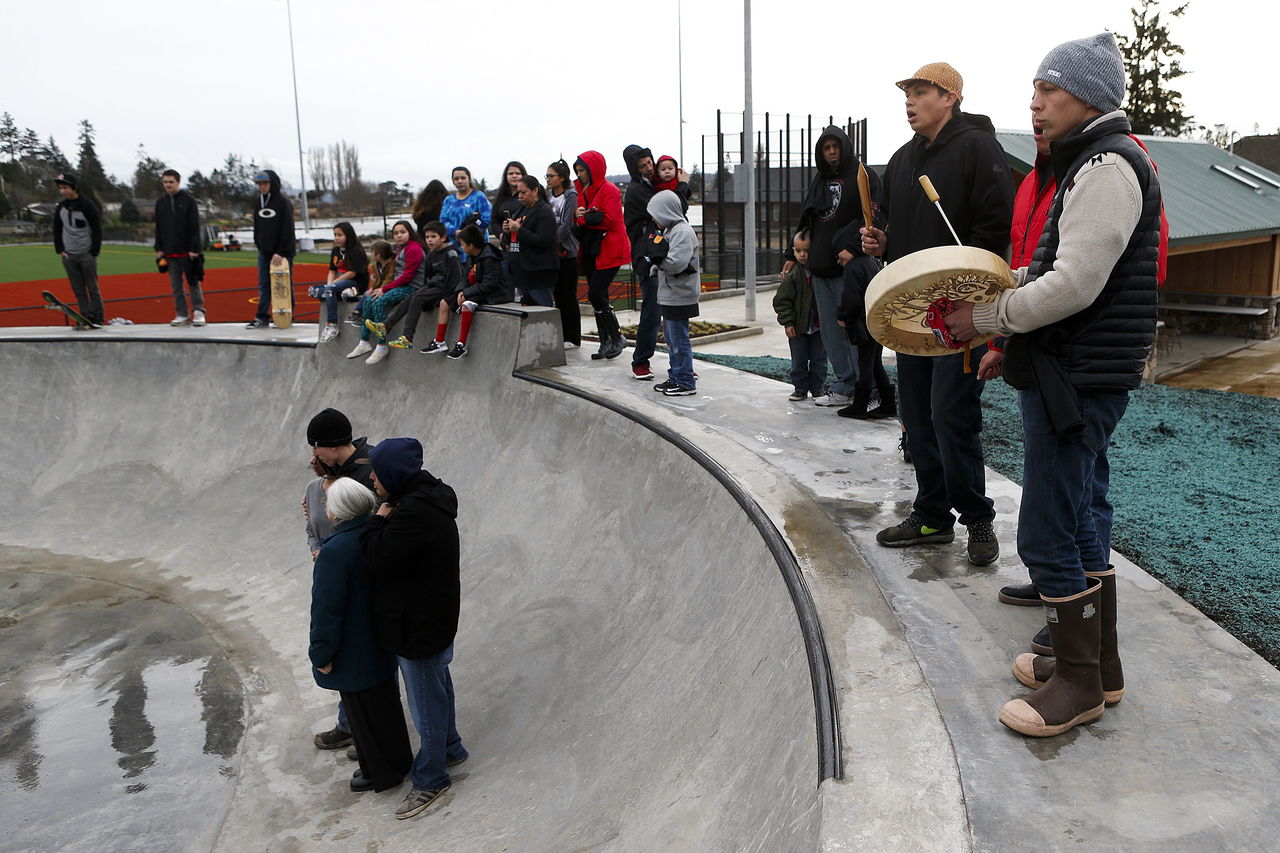 People line the edge of a quarter pipe during Friday’s opening ceremony for the Debra Barto Memorial Skate Park on the Tulalip Reservation.