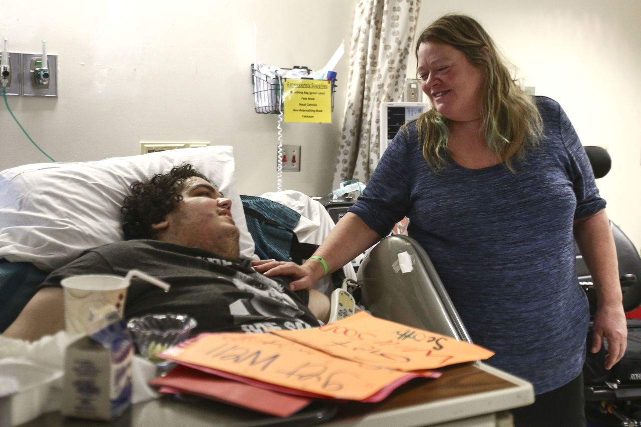 Scott Becktell visits with his mother, Lynn Becktell, at Harborview Medical Center in Seattle on Feb. 12.