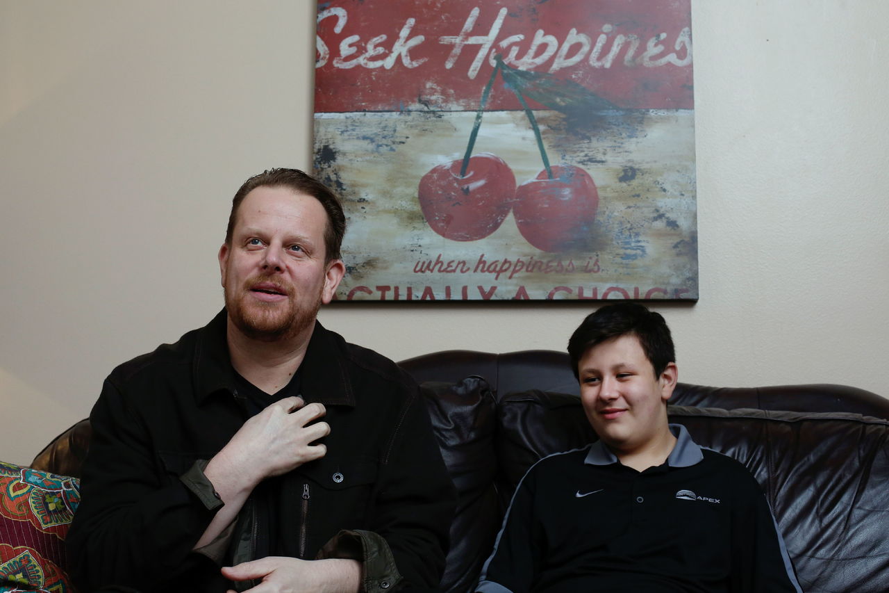 Brian Anaka explains what happened during his heart attack as his son, Taylor, sits with him Monday at their home Monday. Brian likely was saved by CPR performed by Taylor. “There is no doubt in my mind that (Taylor) doing CPR helped save his dad,” paramedic Travis Jacobs said.