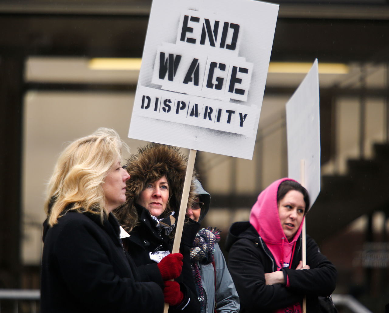 Melody Stewart (from left), Liz Tate and Sarah Graham, Snohomish County Clerks Office employees, display signs during their one-day strike.