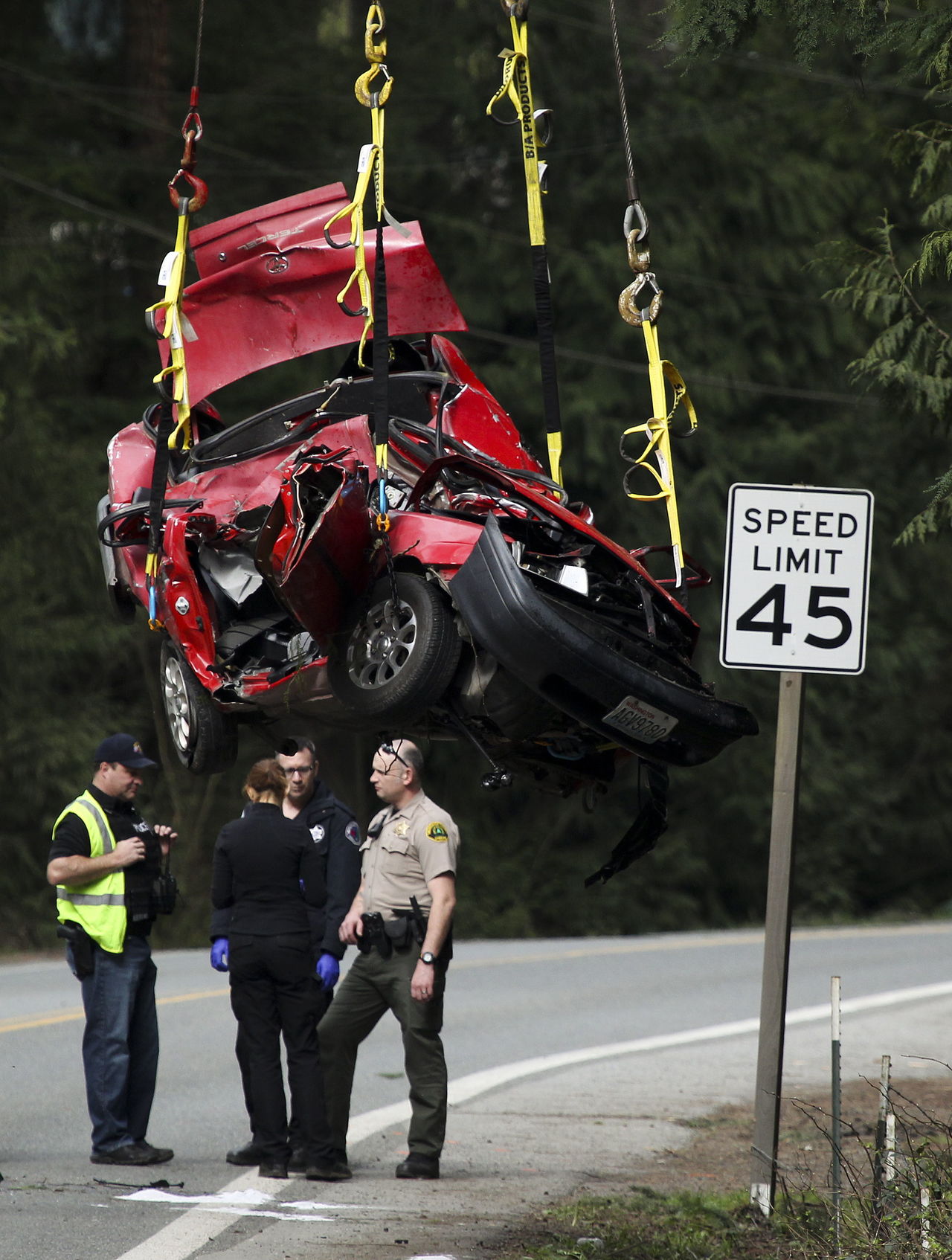 A Toyota Tercel is hoisted for transport on Friday after being removed from the scene of a crash on the Mountain Loop Highway near Canyon Drive, east of Granite Falls.