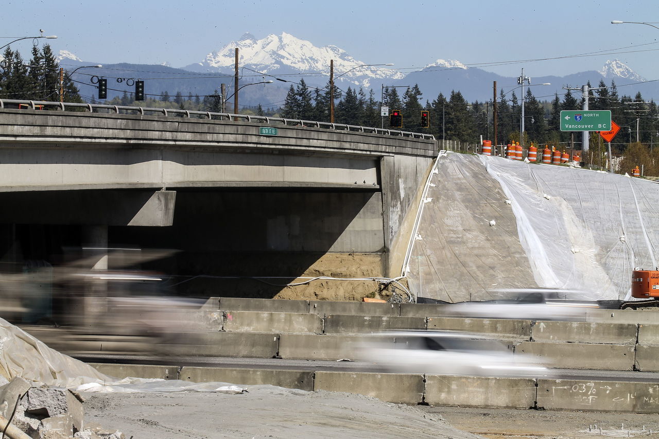 Cars streak along I-5 under the116th Street NE overpass. Demolition of the overpass begins Friday night.