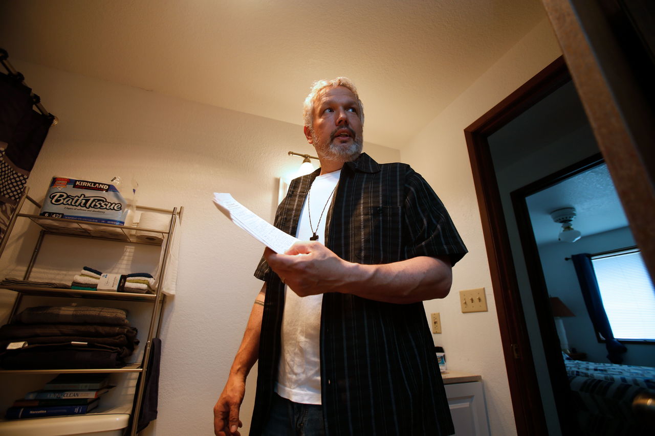 Executive Pastor Dan Hazen holds a list of names that residents can call if they need support as he shows off a residence that will house three men on Thursday in Marysville. Marysville is opening its first home for formerly homeless people, as a pilot project, with only 3 or 4 residents who have been through substance abuse treatment programs, and it’s managed jointly with the faith community.
