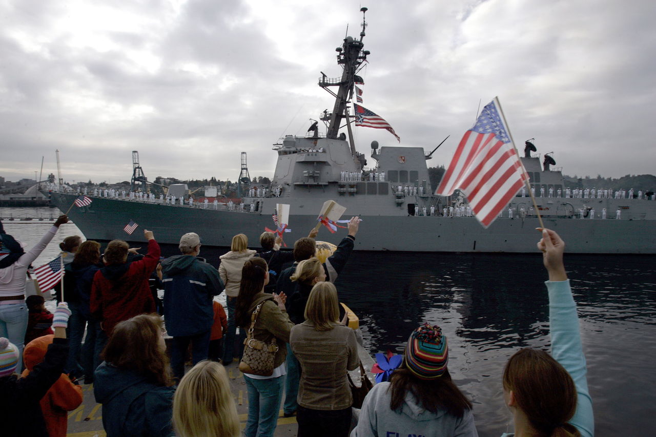 A 2006 photo shows people waving to sailors on the USS Momsen as it pulls into port at The Naval Station Everett in September 2006.
