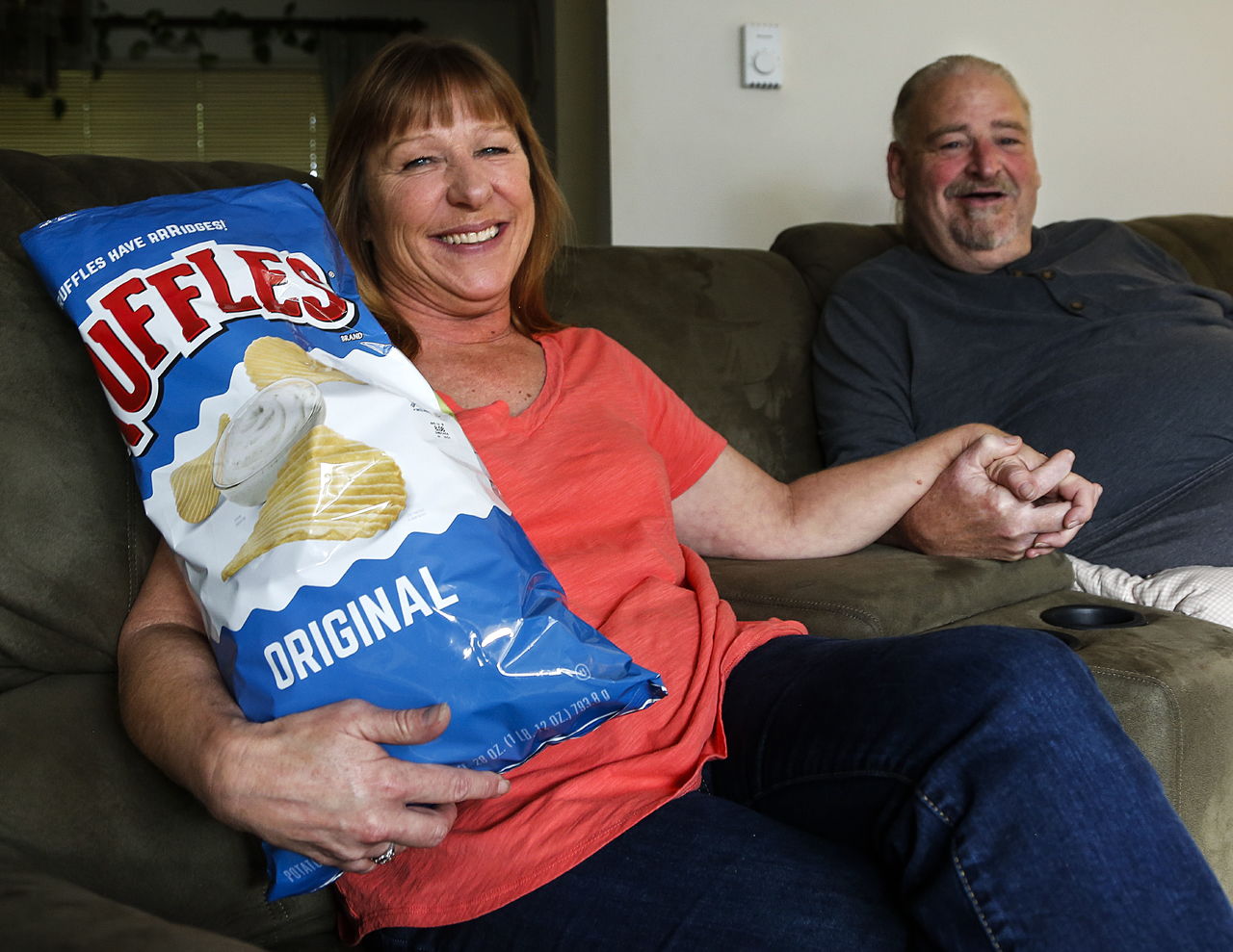 Kristine Moore, with her husband, Bob Metcalfe, and her big bag of Ruffles from Costco. The pair will do something special for a couple of days, Robert said, before Kris begins her cancer treatment.