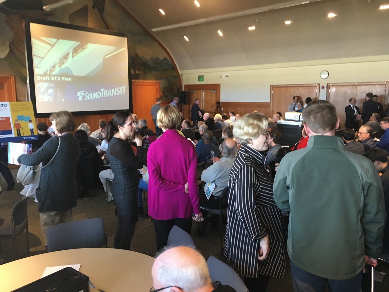 People visit and discuss mass transportation Tuesday during an open house portion of the Sound Transit meeting about the light rail expansion ballot measure, Sound Transit 3 (ST3), being considered this year.